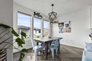 Dining space with baseboards and a chandelier