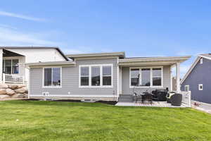 Back of house featuring a yard and a patio area