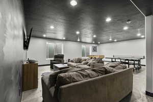 Living room featuring recessed lighting and a textured ceiling
