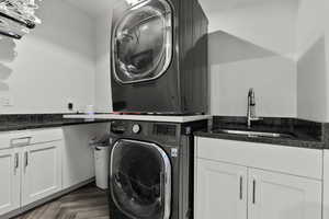 Washroom with cabinet space and stacked washer / drying machine