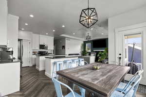 Dining area featuring recessed lighting, a chandelier, and a tray ceiling