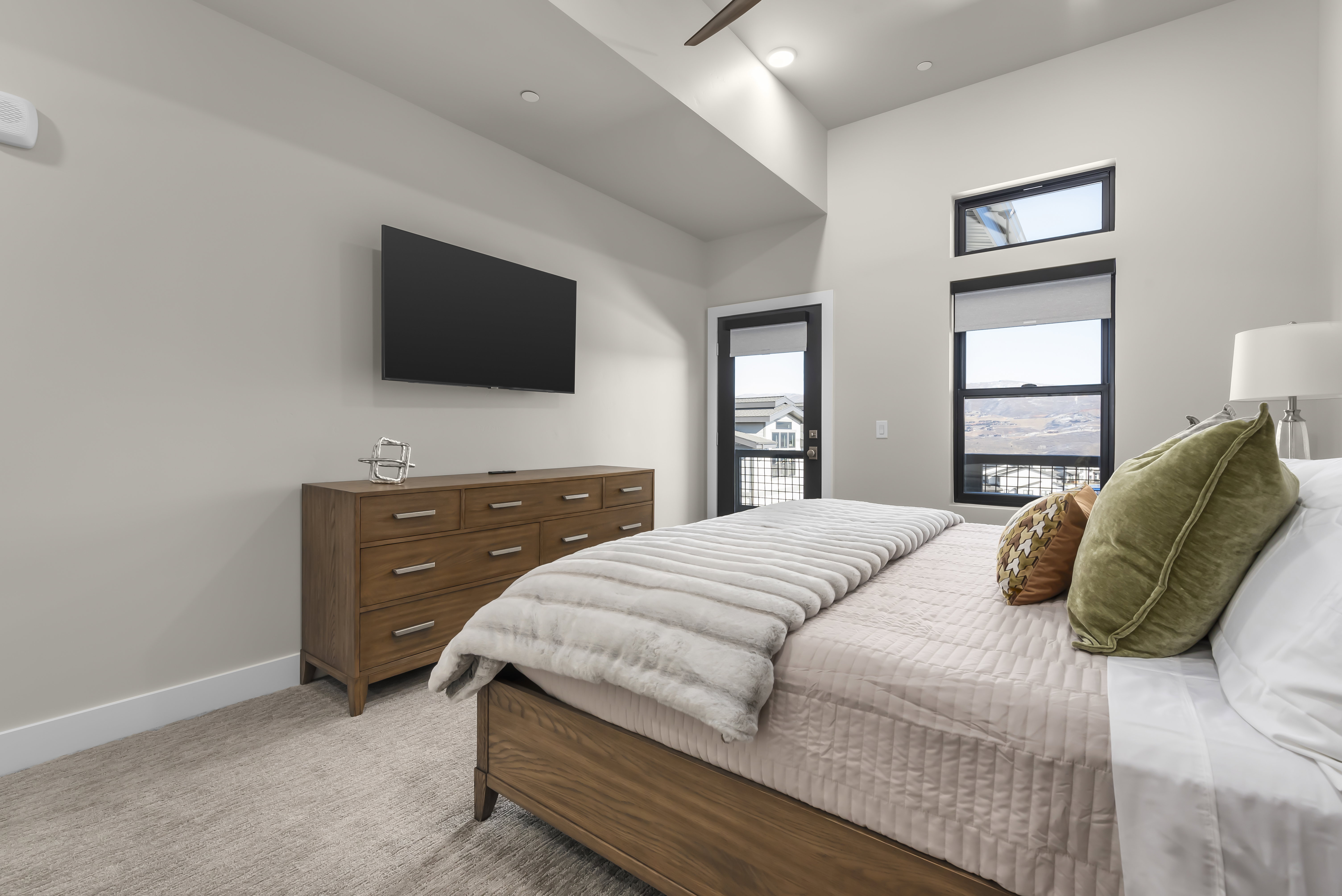 Bedroom featuring light carpet, access to outside, and ceiling fan