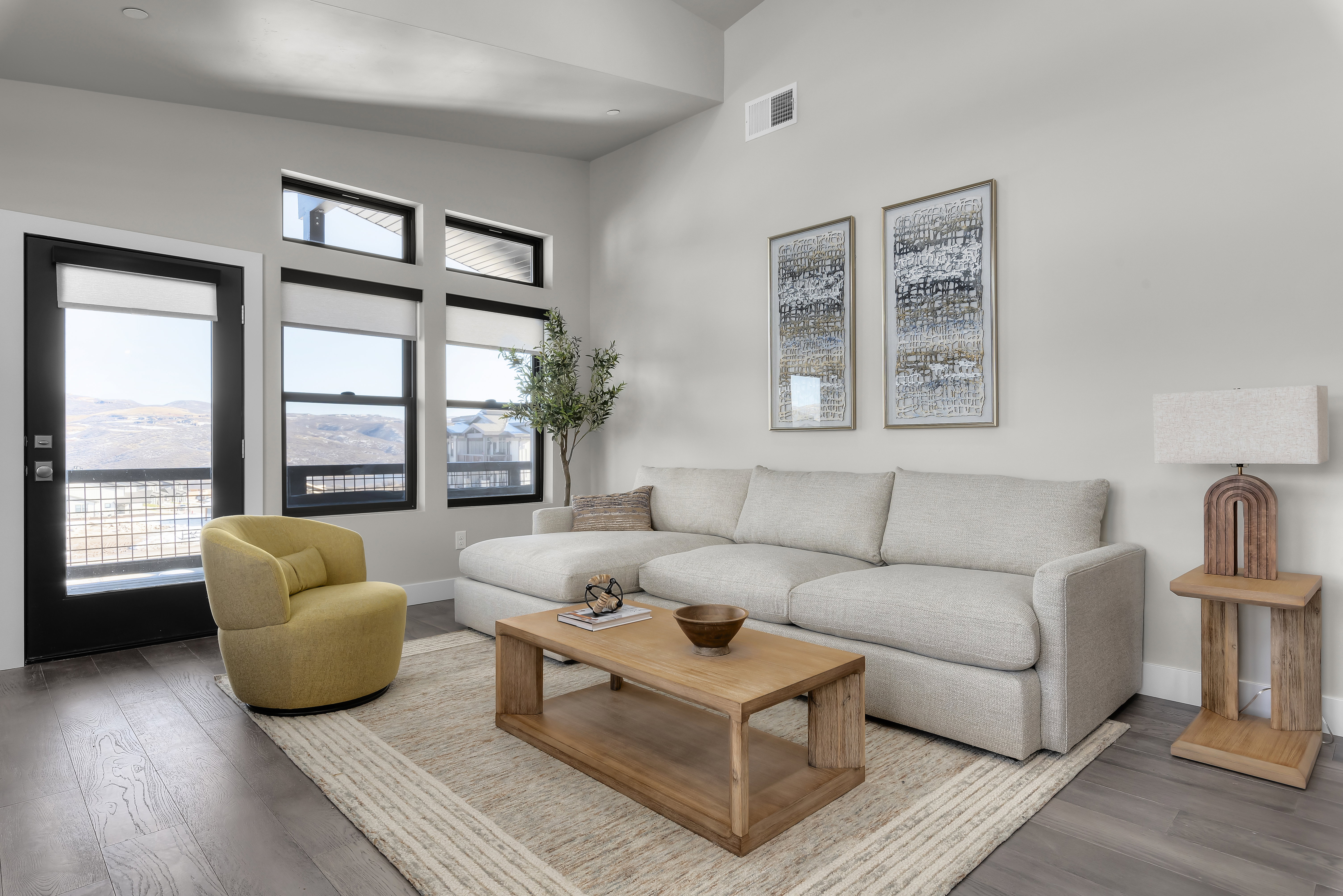 Living area featuring wood finished floors and high vaulted ceiling