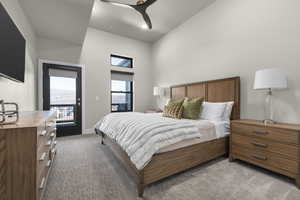 Bedroom featuring access to exterior, light colored carpet, a towering ceiling, and ceiling fan