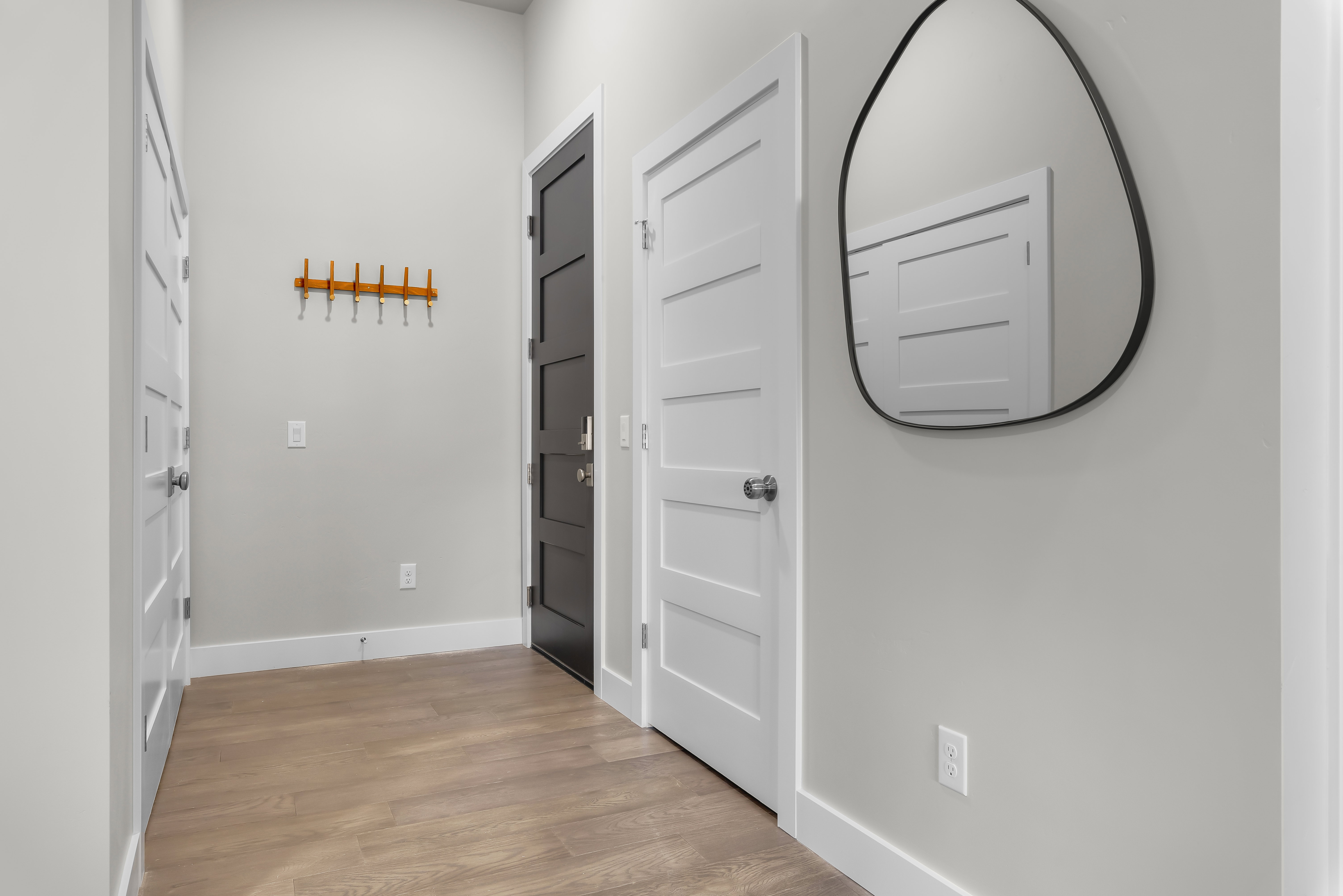 Hall with baseboards and light wood finished floors