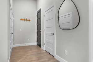 Hall with baseboards and light wood finished floors