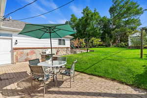 View of patio featuring a playground, outdoor dining space, and a grill