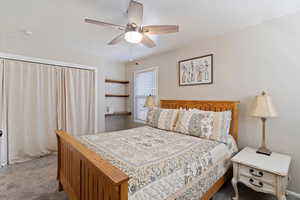 New Carpeted bedroom featuring ceiling fan