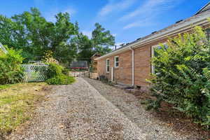 View of North side of home.  RV Parking with a concrete approach and 1/2  concrete driveway with gravel at rear of RV  parking.