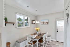 Dining area featuring light wood finished floors and a chandelier