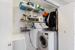 Laundry room with washer and clothes dryer