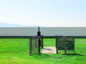 View of yard featuring a gate, a mountain view, and a dog friendly area
