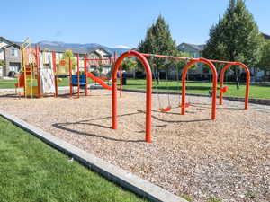 Communal playground with a lawn and a residential view
