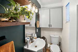 Bathroom featuring vanity and a textured wall