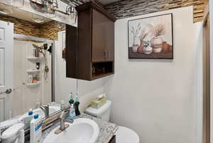 Half bathroom featuring toilet and vanity