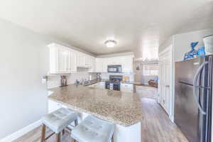 Extra storage in cabinets on bar stool side.