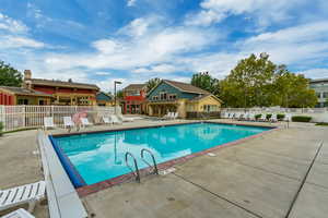 Community pool with a patio