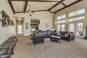 Living area featuring carpet floors, high vaulted ceiling, beamed ceiling, a ceiling fan, and recessed lighting