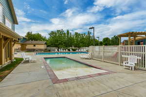 Community pool with a patio