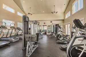 Exercise room featuring high vaulted ceiling and recessed lighting