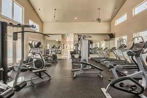 Gym with a towering ceiling, plenty of natural light, and recessed lighting