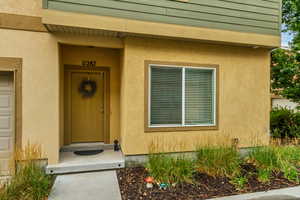 Entrance to property featuring stucco siding
