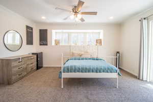 Bedroom with light carpet, crown molding, ceiling fan, and recessed lighting