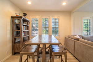 Dining space with healthy amount of natural light, light wood finished floors, and recessed lighting