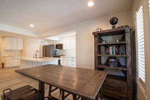 Dining area with recessed lighting and light wood finished floors