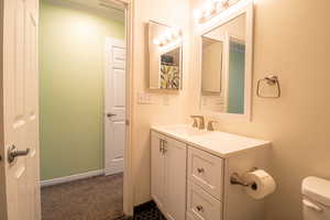 Full bath featuring vanity and toilet