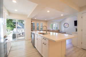 Kitchen with white cabinetry, open floor plan, a kitchen island with sink, stainless steel appliances, and recessed lighting