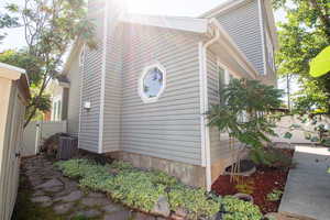 View of side of property with a central AC unit