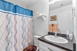 Full bathroom with vanity and a shower with curtain