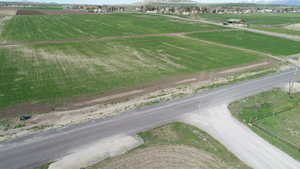 Aerial view of sparsely populated area featuring extensive farmland and a mountain backdrop