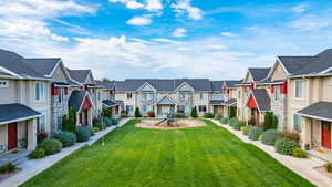 View of home's community with a residential view, a lawn, and covered porch