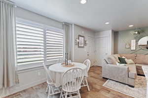 Dining space featuring a textured ceiling, recessed lighting, and light wood finished floors