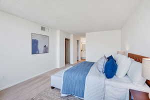 Bedroom featuring carpet floors, a textured ceiling, and ensuite bathroom