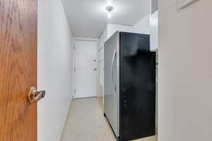 Washroom with baseboards and light floors