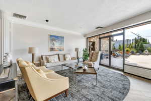 Living room with a textured ceiling and wood finished floors