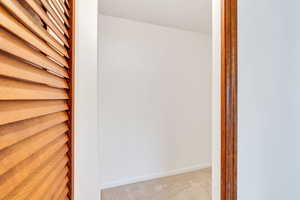 Hallway featuring carpet floors and a textured ceiling