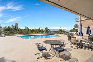 Community pool featuring a patio area and a mountain view