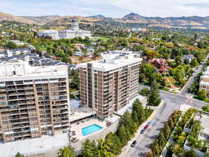 View of urban area featuring a mountainous background and a pool
