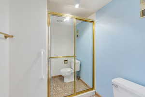 Full bath featuring a stall shower and light tile patterned floors