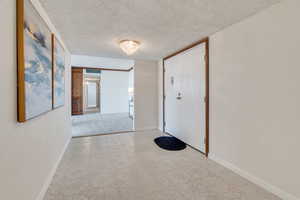 Entry way featuring baseboards and a mosaic tiled floor