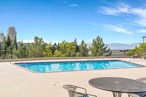 Community pool featuring a patio and a mountain view