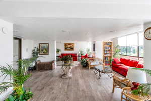 Living area with wood finished floors and a textured ceiling