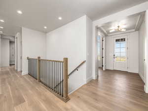 Entryway with light wood-style floors and recessed lighting