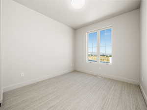 Unfurnished room featuring carpet and baseboards