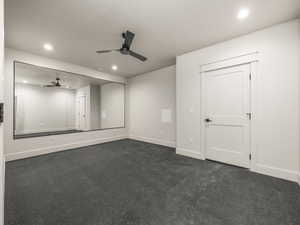 Unfurnished room featuring recessed lighting, dark colored carpet, and ceiling fan