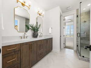 Bathroom with double vanity and a shower stall